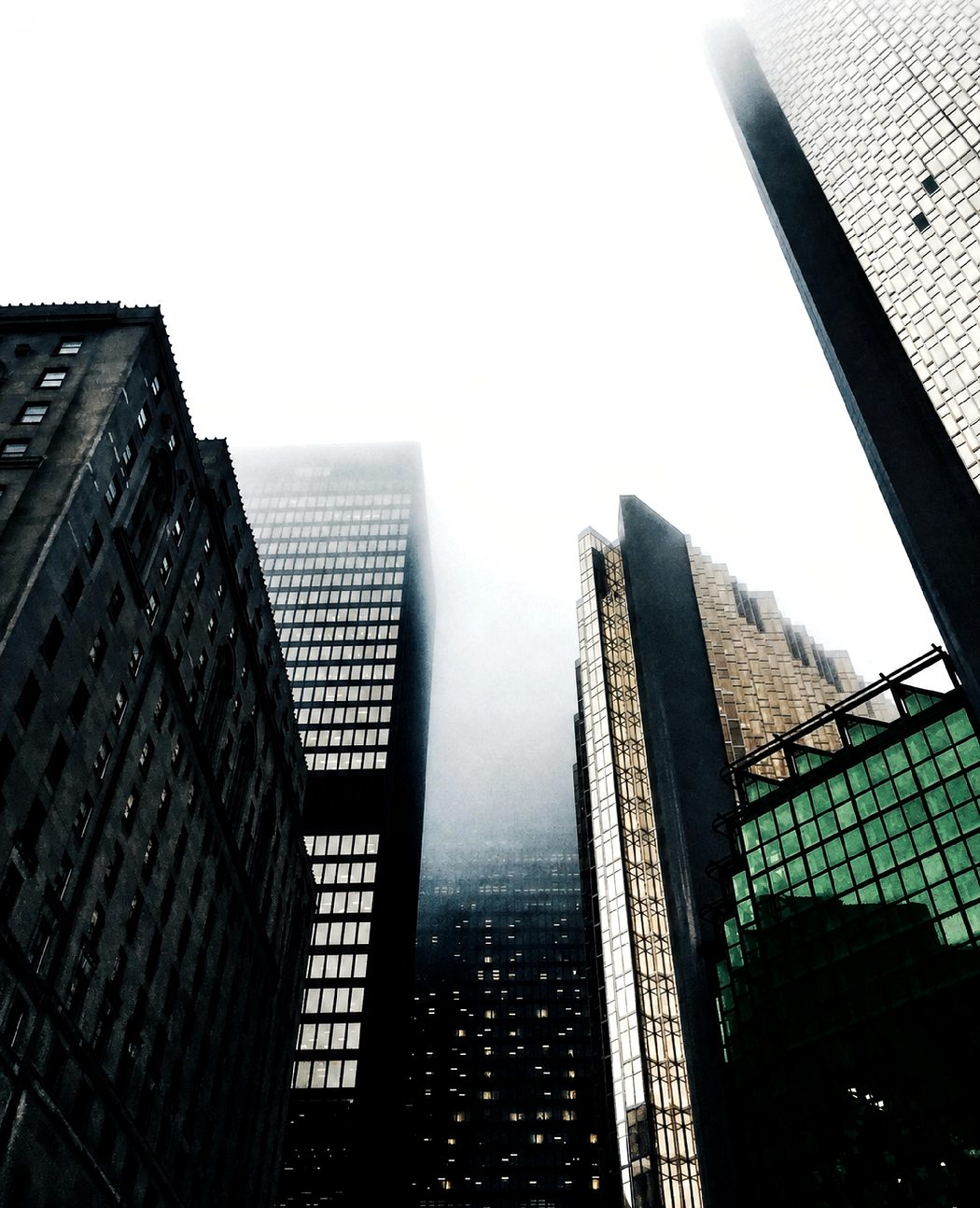 Looking up at Business Bay towers through morning fog